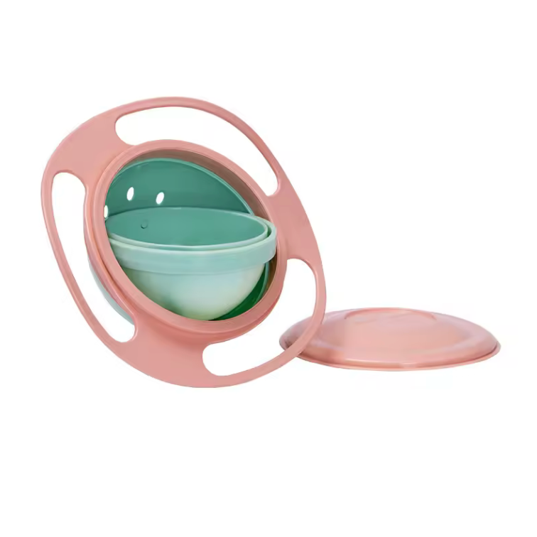 Pink and green baby sippy cup on a white background