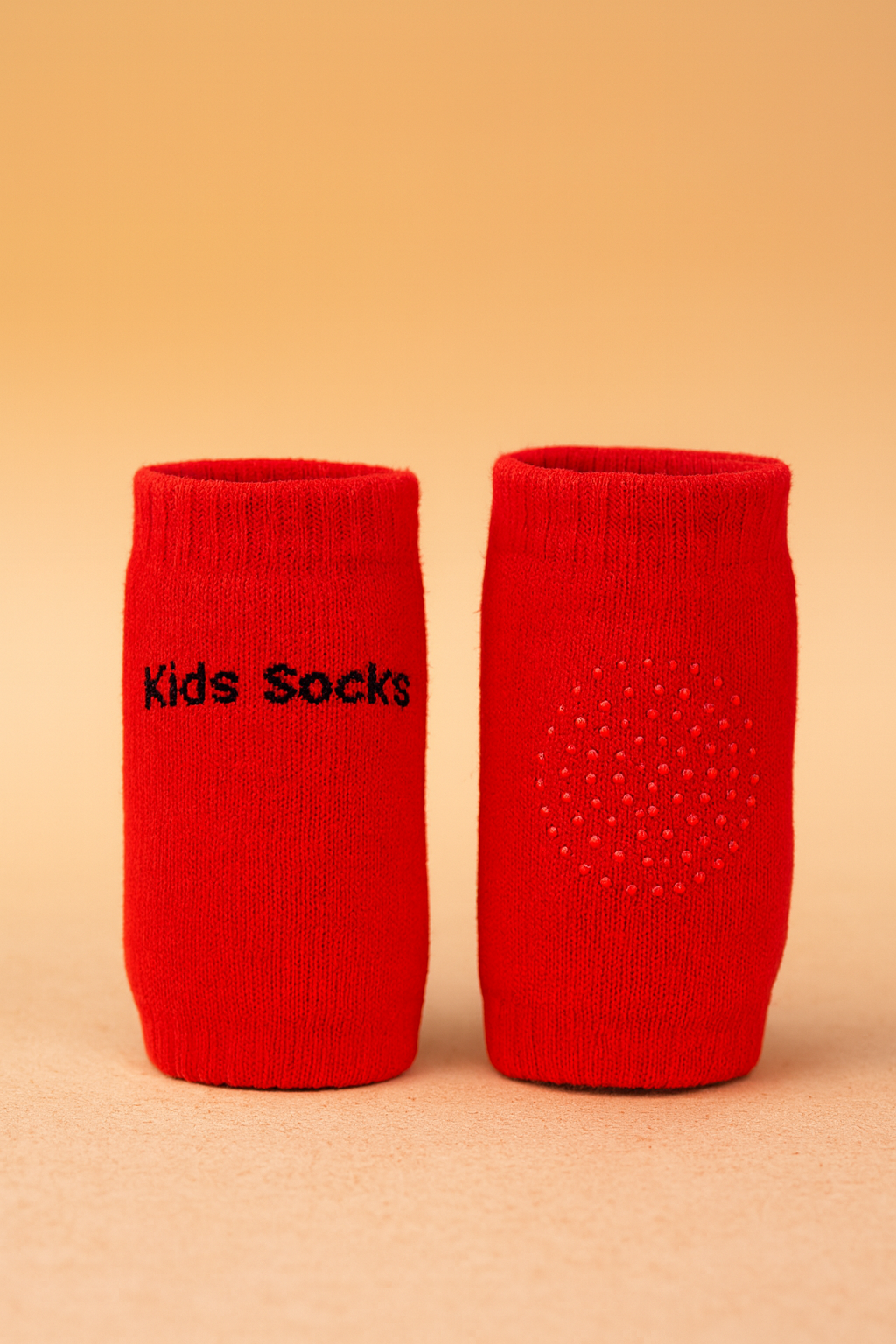 Two red socks with 'Kids Socks' text on a beige background