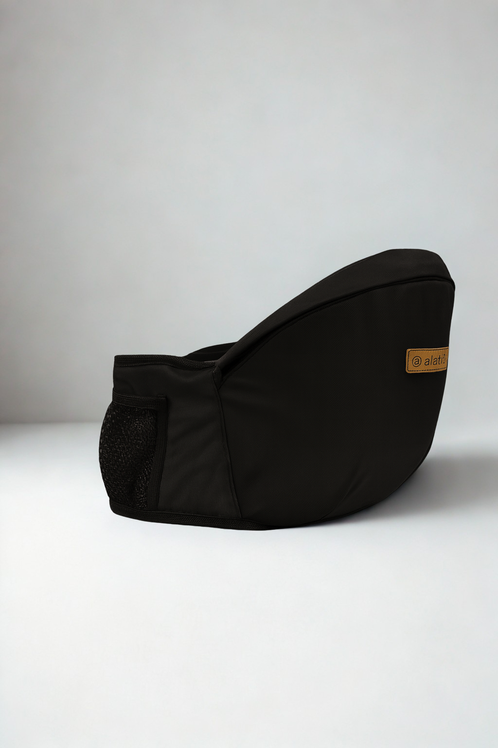 Black bean bag chair on a white surface with a neutral background