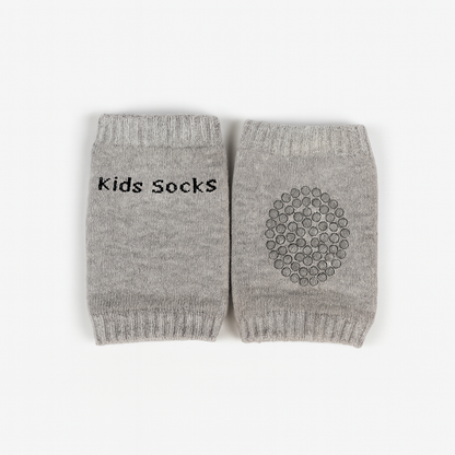 Pair of gray kids socks with 'kids socks' text on one and a pattern on the other, on a white background.