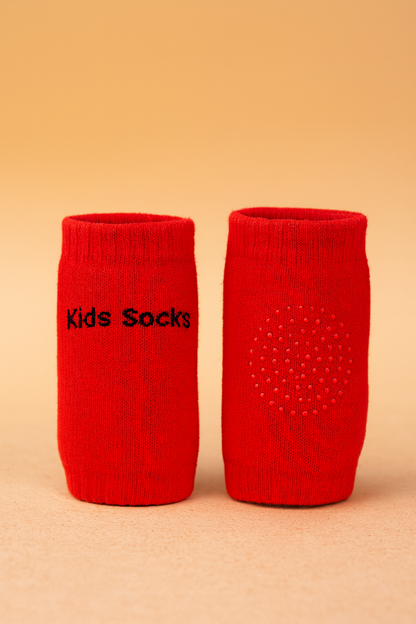 Two red socks with 'Kids Socks' text on a beige background