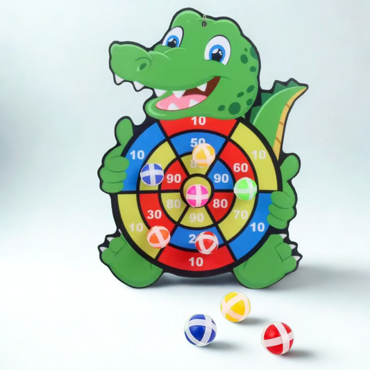 Children's dartboard shaped like a crocodile with colorful darts on a light gray background