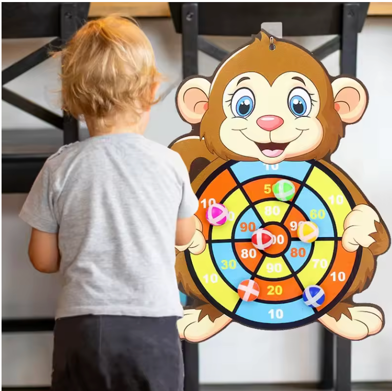 Child playing with a monkey-themed dartboard